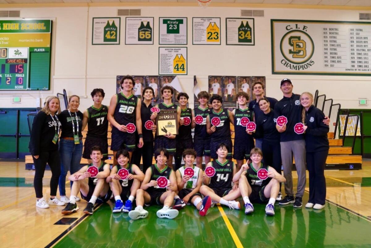 The Sage Hill boys' volleyball team poses with the championship plaque after winning the CIF Division 4 final on Saturday.
