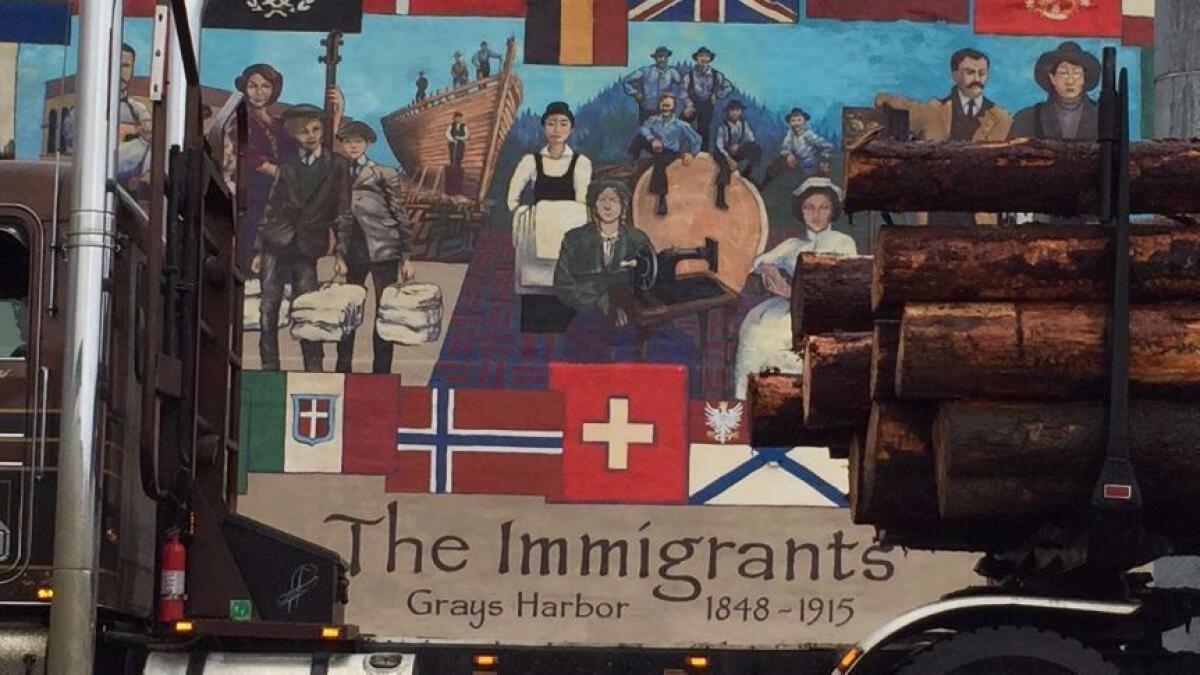 A logging truck is parked in front of a mural in Aberdeen, Wash. Many in the Washington timber industry voted for Donald Trump for president.