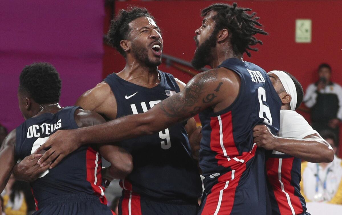 Kareem Maddox, top left, Jonathan Octeus, far left, Sheldon Jeter, top right, and Dominique Jones, far right, celebrate their victory over Puerto Rico after their men's basketball 3x3 final match at the Pan American Games in Lima, Peru on July 29.