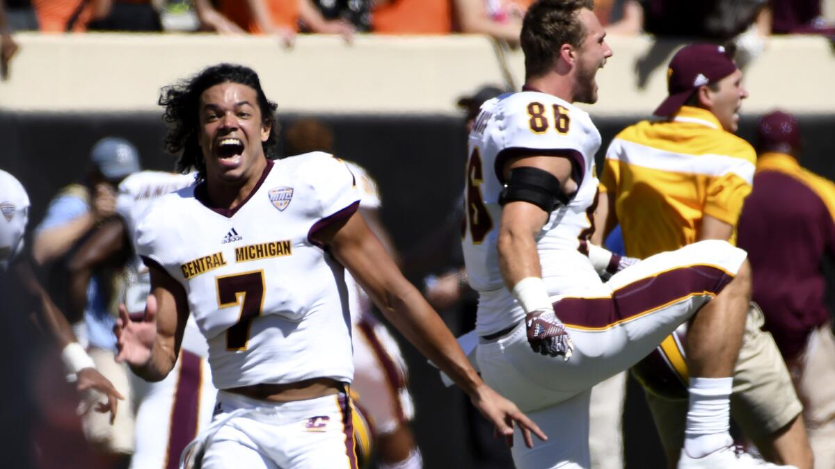 Defensive back Amari Coleman (7) and his Central Michigan teammates celebrate after upsetting Oklahoma State on a Hail Mary-and-lateral play to end the game Saturday.