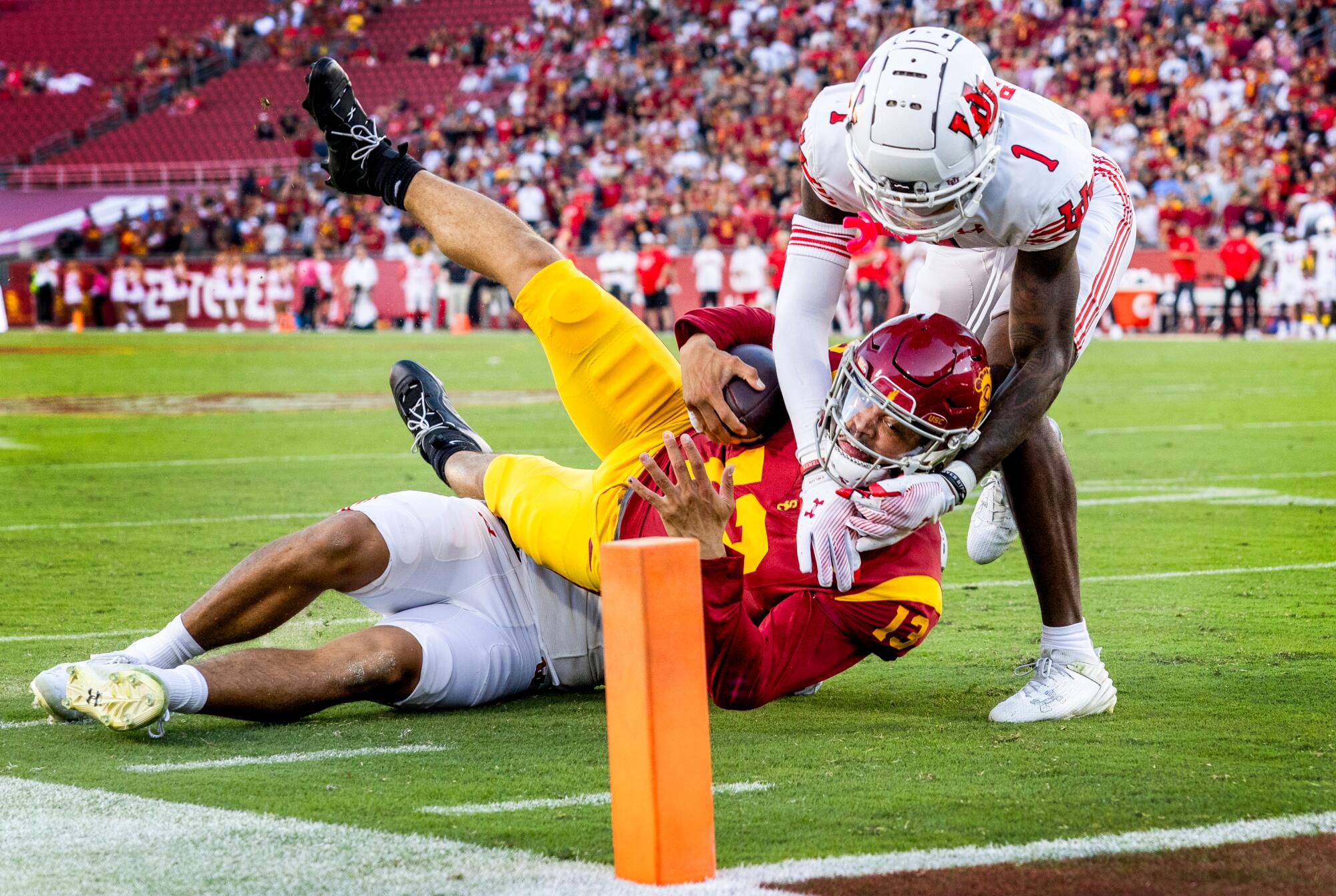 USC's Caleb Williams is stopped just short of the goal line by Utah defensive end Jonah Elliss and cornerback Miles Battle.