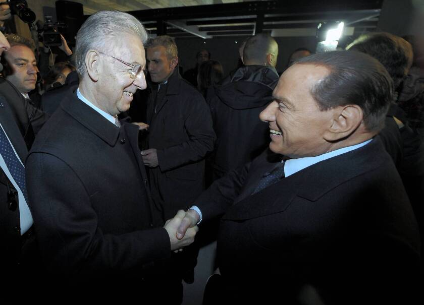Italian Prime Minister Mario Monti, left, and former Prime Minister Silvio Berlusconi attend an event in Milan. Berlusconi has come under fire for his defense of former dictator Benito Mussolini.
