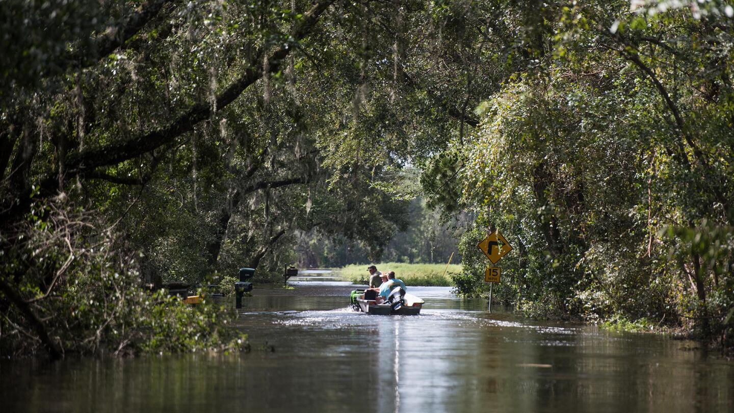 People use a boat and four wheeler to navigate flood waters caused by Hurricane Irma Sept. 12, 2017 near Palatka, Florida.