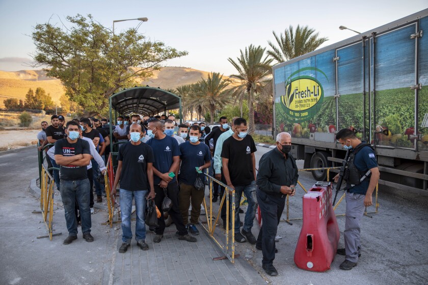 Palestinians laborers line up to cross a checkpoint near Jerusalem.