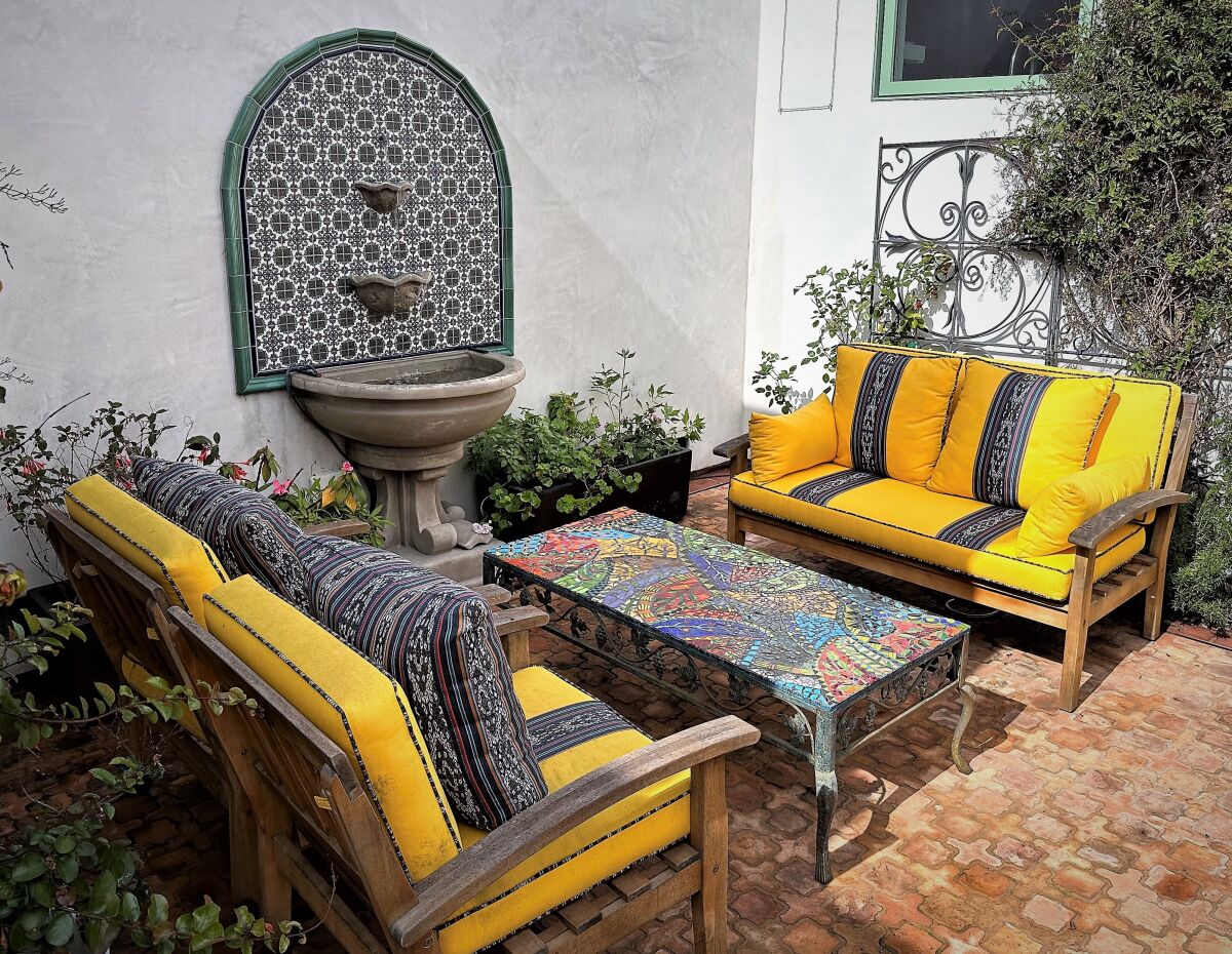 An updated patio with fountain, added to the 1930s Spanish revival bungalow.