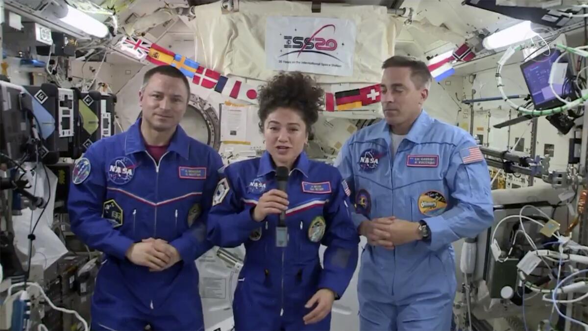 U.S. astronaut Jessica Meir broadcasts from the space station with crewmates Andrew Morgan, left, and Chris Cassidy