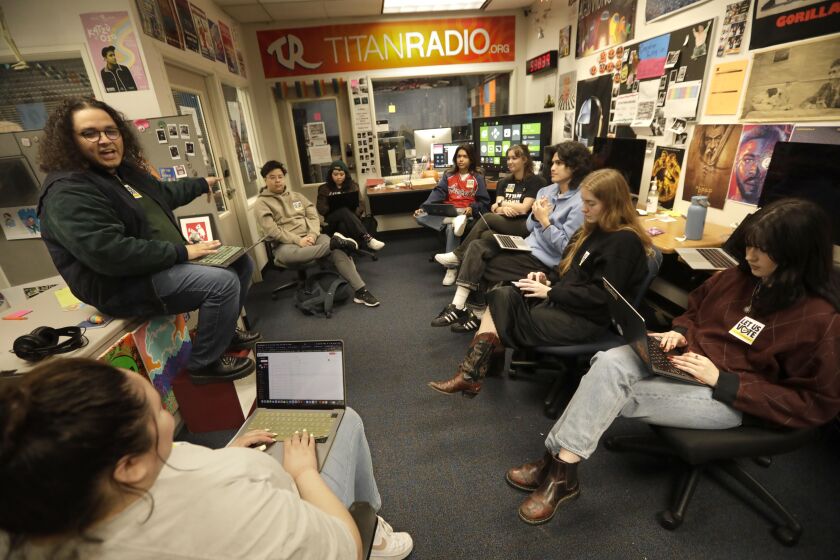 FULLERTON, CA - MAY 1,2023 - California State University Fullerton student assistant Cameron Macedonio, 20, left, oversees a staff meeting at Titan Radio where he works as General Manager at California State University Fullerton on May 1, 2023. Macedonio is also a labor organizer who is fighting along with thousands of Cal State undergraduate student assistants who are seeking to establish a union. They want higher pay and benefits. The staff at Titan Radio also work as student assistants. (Genaro Molina / Los Angeles Times)