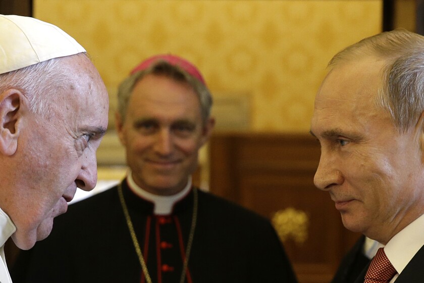 FILE - Pope Francis meets Russian President Vladimir Putin on the occasion of their private audience at the Vatican on June 10, 2015. Pope Francis went to the Russian Embassy on Friday, Feb. 25, 2022 to personally “express his concern about the war,” the Vatican said, in an extraordinary, hands-on papal gesture that has no recent precedent. Usually, popes receive ambassadors and heads of state in the Vatican, and diplomatic protocol would have called for the Vatican foreign minister to summon the ambassador. (AP Photo/Gregorio Borgia, Pool)