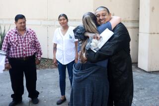 Jose Olivares hugs his attorney Lauryn Barbosa Findley Wednesday after he was released from Los Angeles County Sheriff Men's Central Jail Wednesday. His parents, Martina and Jose Guadalupe Olivares look on.