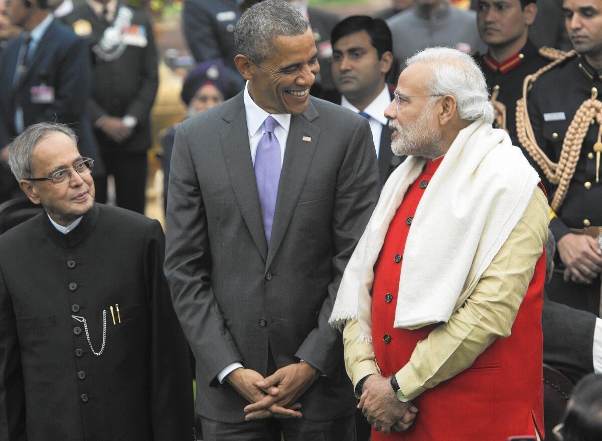 President Obama and Indian Prime Minister Narendra Modi, with Indian President Pranab Mukherjee at left, attend a reception at Rashtrapati Bhawan, the presidential residence in New Delhi.