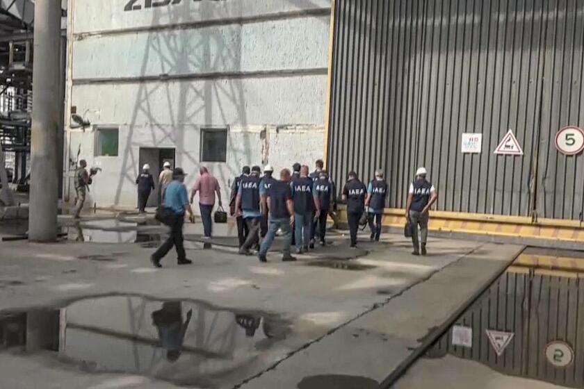 In this handout photo taken from video released by Russian Defense Ministry Press Service on Friday Sept. 2, 2022, members of International Atomic Energy Agency (IAEA) walk while inspecting the Zaporizhzhia Nuclear Power Plant in Enerhodar, southeastern Ukraine Thursday, Sept. 1, 2022. A U.N. inspection team has arrived at Ukraine's Zaporizhzhia nuclear power plant on a mission to safeguard it from catastrophe. It reached the site Thursday amid fighting between Russian and Ukrainian forces that prompted the shutdown of one reactor and underscored the urgency and the danger of the task. (Russian Defense Ministry Press Service via AP)