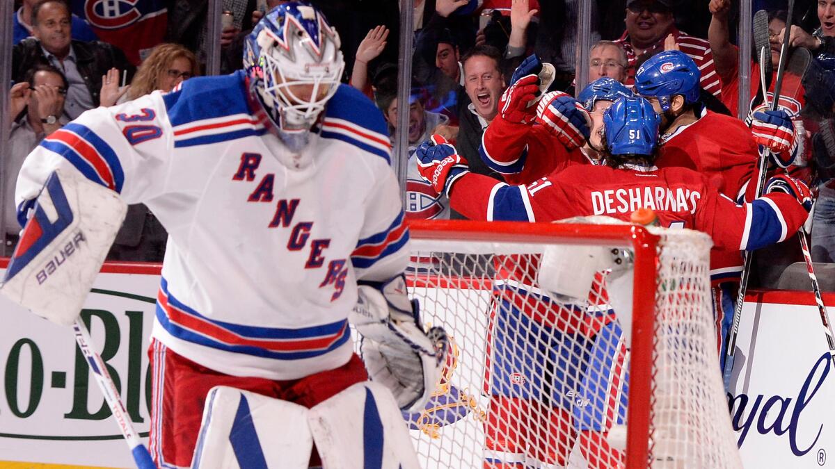 Montreal Canadiens players, right, celebrate a goal scored by Max Pacioretty as New York Rangers goalie Henrik Lundqvist looks on during the second period of the Canadiens' 7-4 win in Game 5 of the Eastern Conference finals Tuesday.