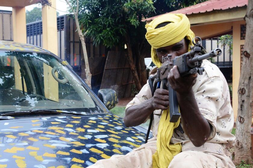 A Seleka fighter poses with his weapon in the Central African Republic capital, Bangui, in July.