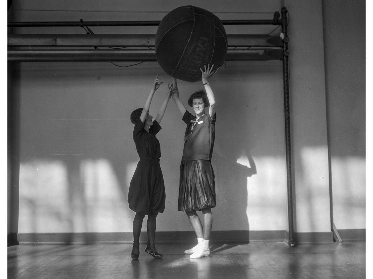 Feb. 16, 1926: Selma Postner holds the cage ball over her head while Lillian Cassel, a few inches shorter, reaches out to grab it.