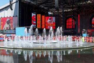 A wide view as fountains rise in front of the NFL Draft Theatre 