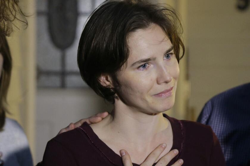 In this March 27, 2015 photo Amanda Knox talks to reporters outside her mother's home, in Seattle, WA, United States. Knox says she is returning to Italy for the first time since she was convicted and imprisoned, but ultimately acquitted, for the murder and sexual assault of her British roommate Meredith Kercher in the university hilltop town of Perugia. Knox on Twitter that I'm honored to accept their invitation to speak to the Italian people at this historic event and return to Italy for the first time after she was invited to attend a conference June 14-15 in Modena organized by the Italy Innocence Project, which seeks to help people who have been convicted for crimes they did not commit. (AP Photo/Ted S. Warren)