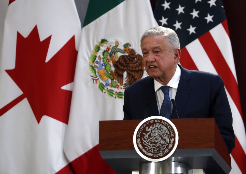 FILE - In this Dec. 10. 2019 file photo, Mexico's President Andres Manuel Lopez Obrador speaks during an event to sign an update to the North American Free Trade Agreement, at the National Palace in Mexico City. Mexico celebrated on Wednesday, July 1, 2020, the implementation of the new free trade agreement with Canada and the United States that it hopes will lead to more investment in its struggling economy. (AP Photo/Marco Ugarte, File)