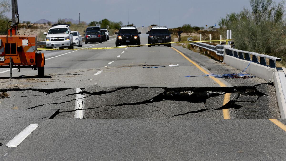 California Highway Patrol vehicles block a section of Interstate 10 between Coachella, Calif., and the Arizona border, where Sunday's flash floods washed out a bridge over a desert wash.