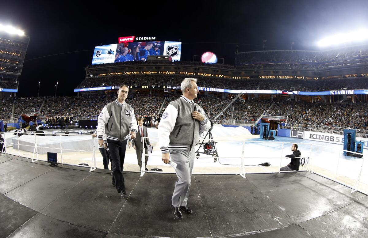 Kings Coach Darryl Sutter, right, and assistant coach John Stevens walk to their bench before the team's game against San Jose on Saturday at Levi's Stadium in Santa Clara.
