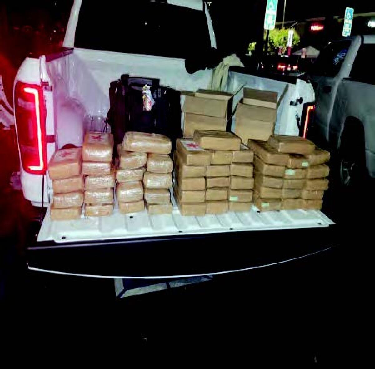 Brown-paper packages on the bed of a pickup truck.
