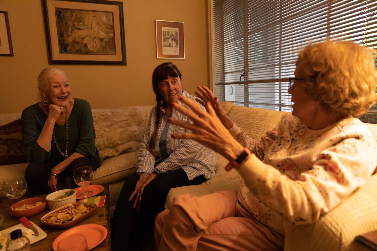 Janed Guymon Casady, Suzanne Sorger and Judy Wenker talk during a small in-home gathering.