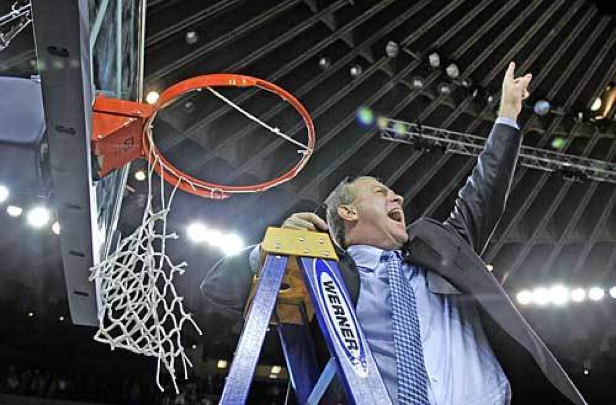 VICTORY: Bruins head coach Ben Howland lets out a scream for the fans before he finishes cutting down the net after beating the Memphis Tigers 50-45.