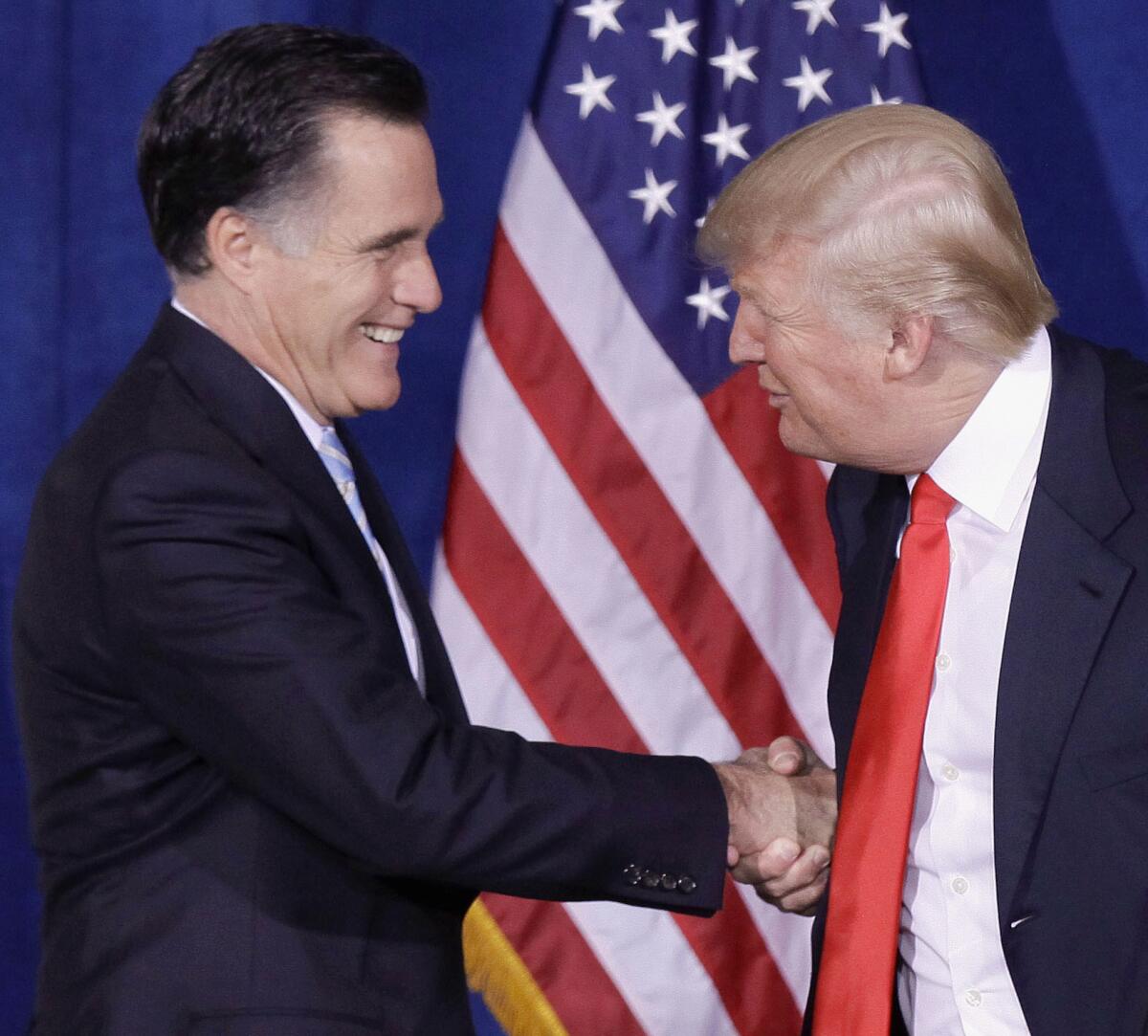 Donald Trump greets then-Republican presidential candidate Mitt Romney, left, at a 2012 news conference in Las Vegas during which he endorsed the former Massachusetts governor.