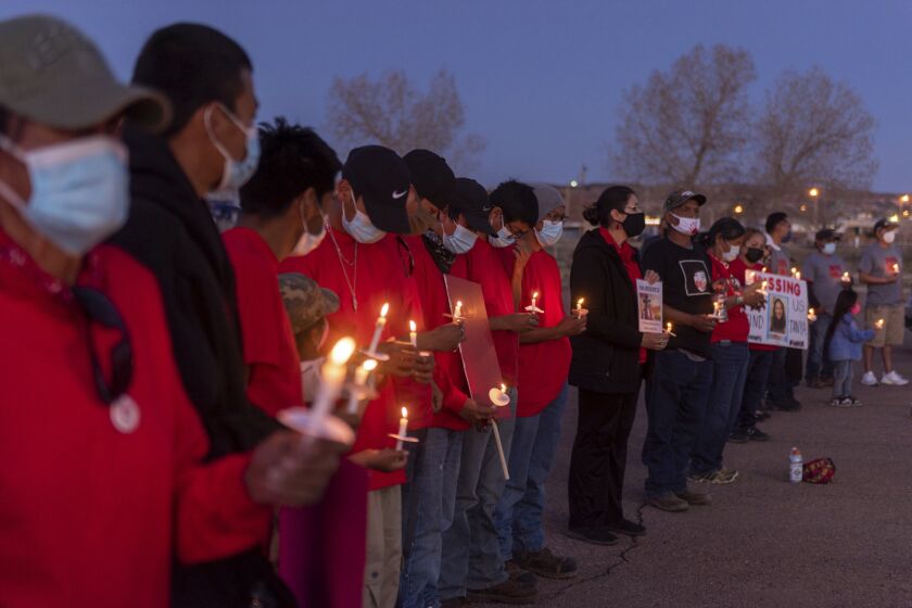 In this image provided by the Navajo Nation Office of the Speaker, family members and advocates participating in a candlelight vigil on the Navajo Nation, Wednesday, May 5, 2021, near Window Rock, Ariz., to commemorate a day of awareness for the crisis of violence against Indigenous women and children. (Byron C. Shorty, Navajo Nation Office of the Speaker via AP)