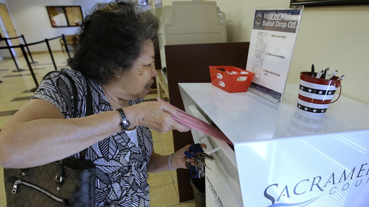 Lei Linh-Pham drops off her ballot at the Sacramento County Registrar of Voters office on May 30. Sacramento County is one of five counties that have embraced a new, optional state law that closes neighborhood polling places in favor of mail ballots and vote centers.