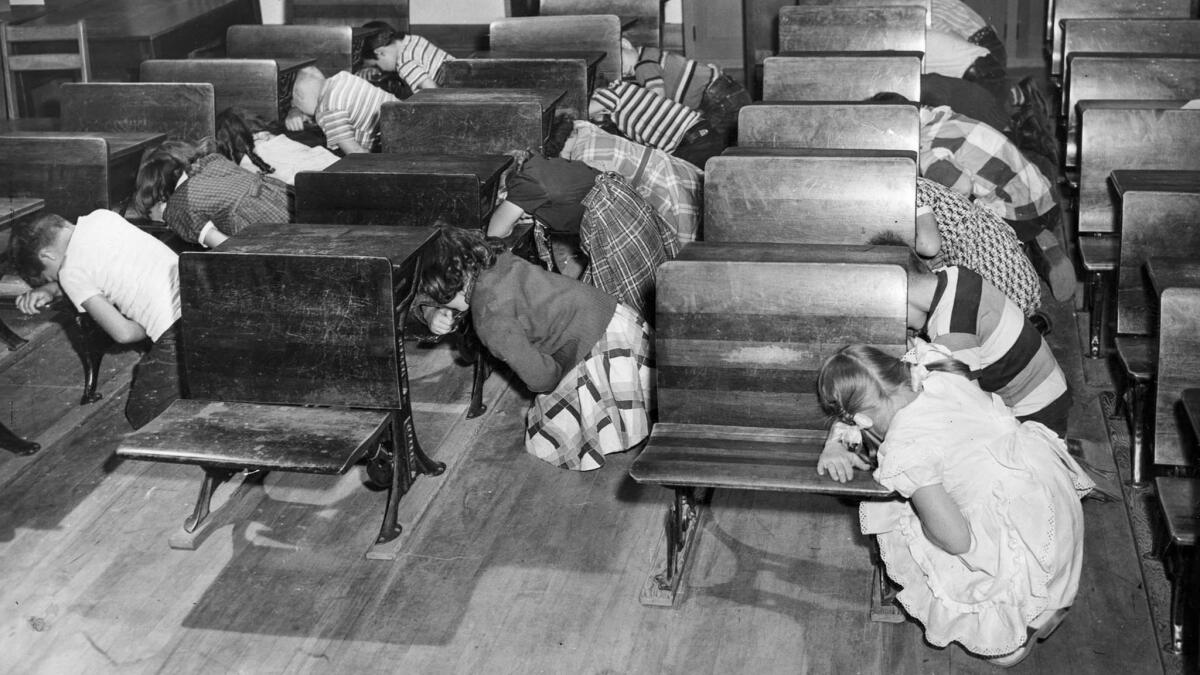 Dec. 1, 1950: Third-graders at Clifford Street School kneel at desks and cover their faces