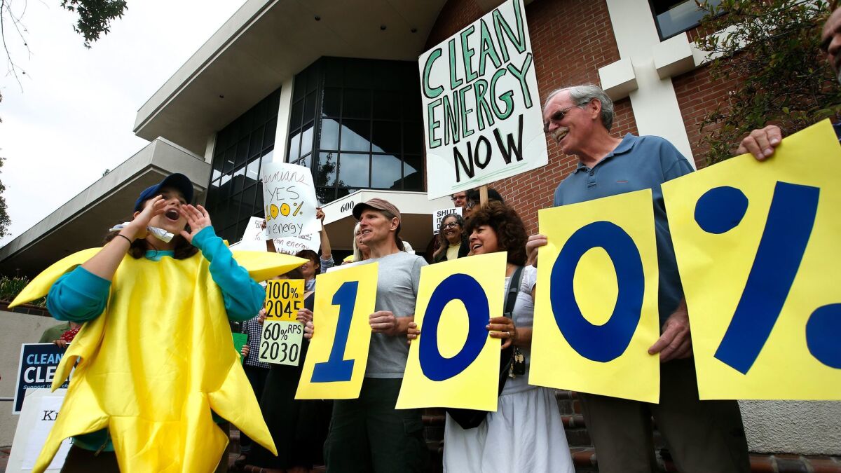 Dressed as the sun, Sierra Club organizer Katya English rallies with other environmentalists in front of Assemblyman Chris Holden's district office in Pasadena on Thursday.