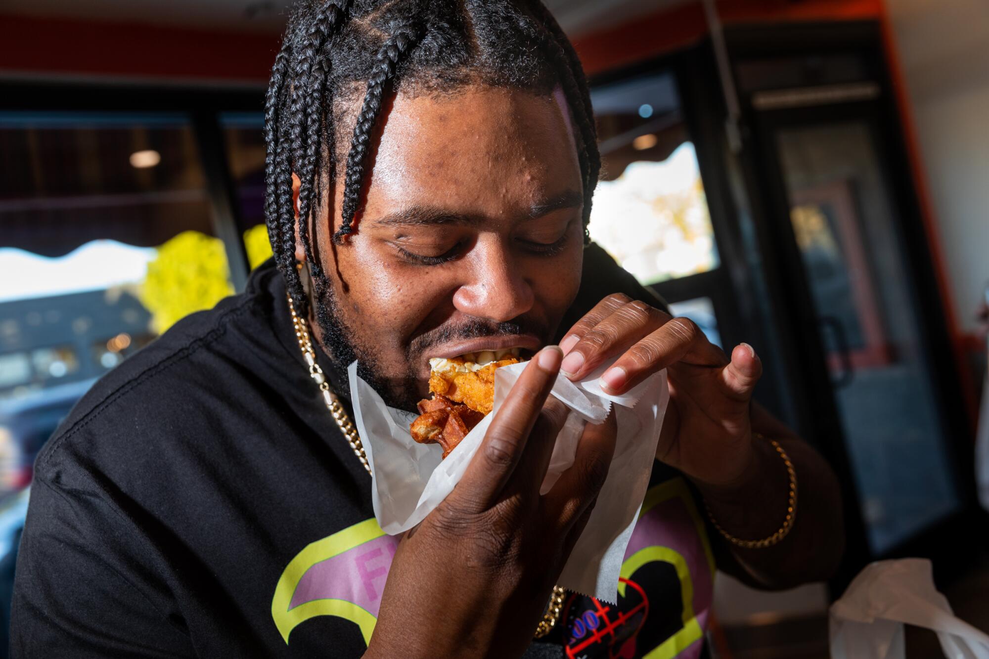 Danny Shell couldn't stop smiling after biting into his waffle slider at CJ's Wings.