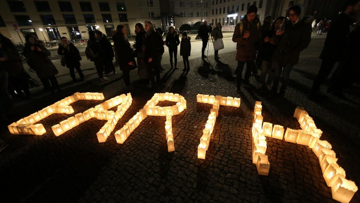 Participants take part in Earth Hour 2018 in front of Berlin's Brandenburg Gate on Saturday. Organizers say Earth Hour has participants in 154 countries and territories and over 5,000 cities agreeing to switch off their lights for one hour.