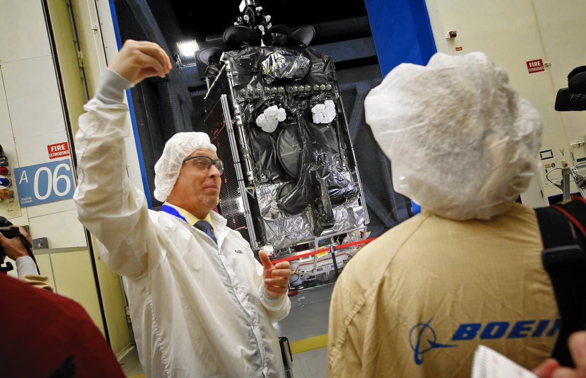 Mark Spiwak, president of Boeing Satellite Systems International, talks about a new all-electric communications satellite at Boeing's satellite building facility in El Segundo in January.