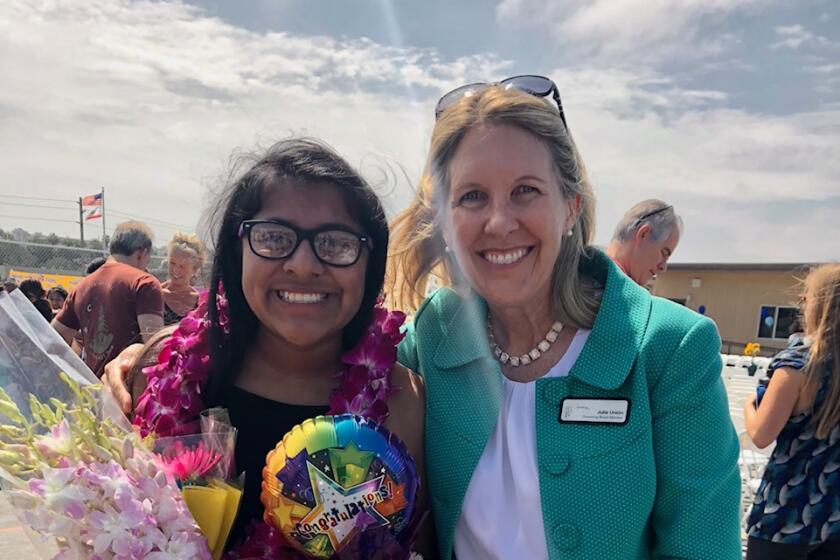 Julie Union with a student at sixth grade promotion.