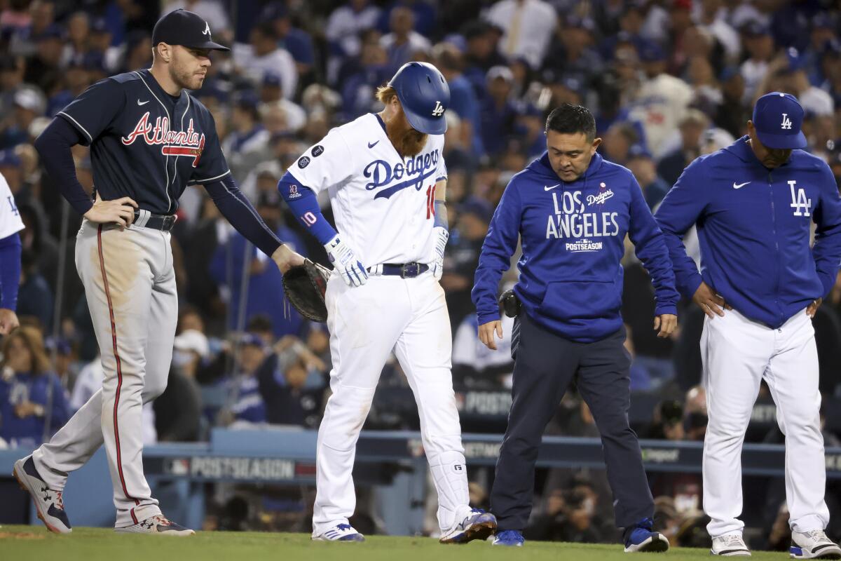 Dodgers' Justin Turner reacts to an apparent injury after hitting into a double play.