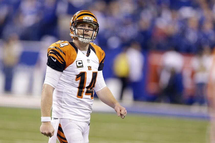 Cincinnati quarterback Andy Dalton walks to the sideline after fumbling the ball against Indianapolis during a wildcard playoff game on Jan. 4.