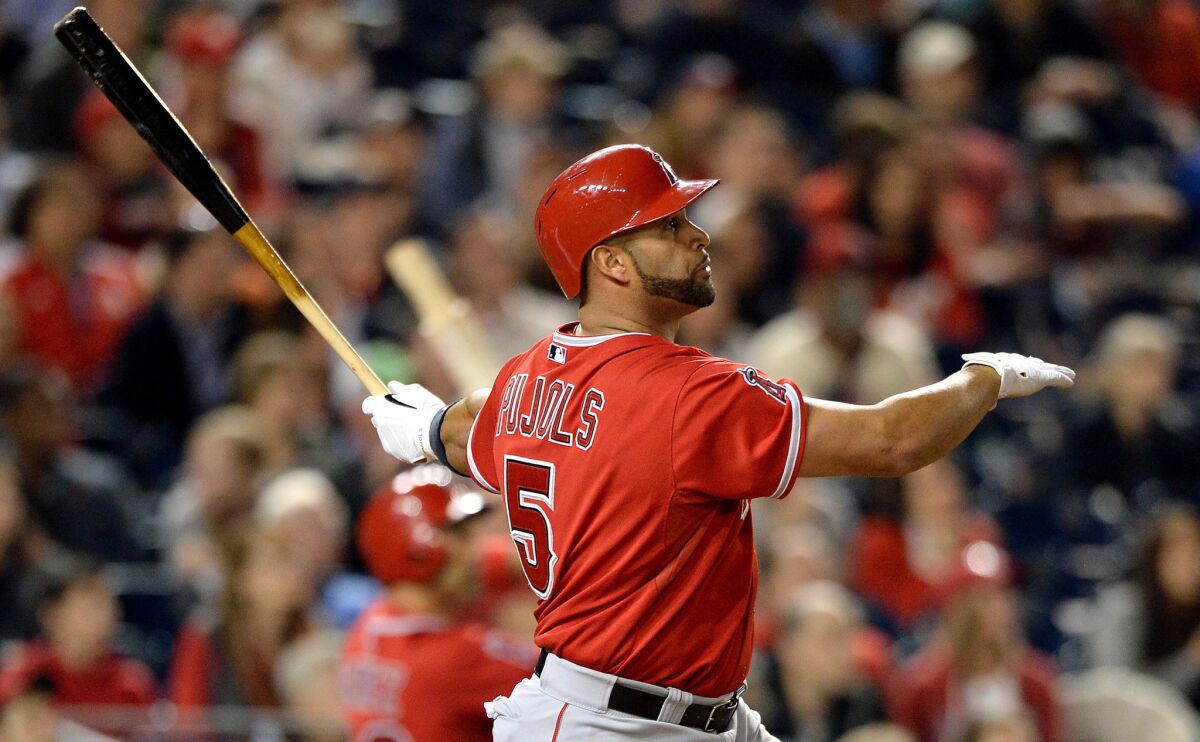Angels slugger Albert Pujols hits his 500th career home run in the fifth inning of Tuesday's game against the Washington Nationals. Pujols hit his 499th career blast in the first inning.