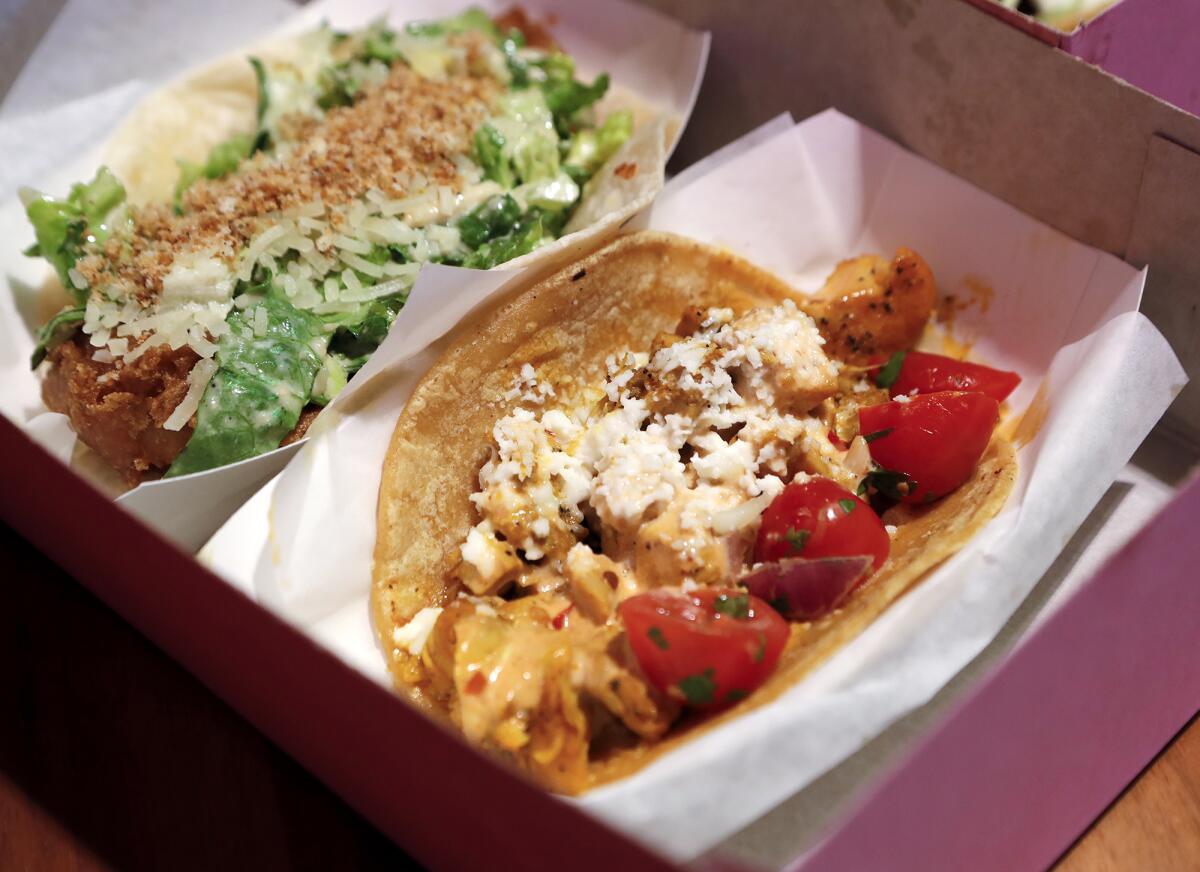 A chicken, foreground, and lightly breaded fish taco at the new Chicas Tacos in Rodeo 39 center in Stanton.