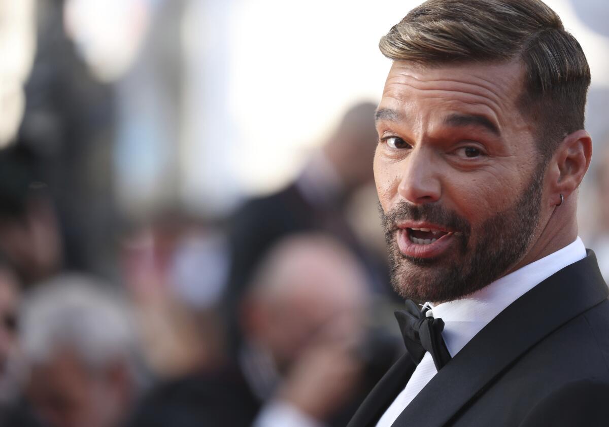 Ricky Martin looks at the camera while wearing a tuxedo and bowtie