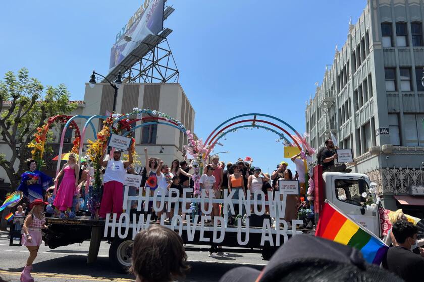 A float at Los Angeles' Pride parade in Hollywood reads "I hope u know how loved u are."