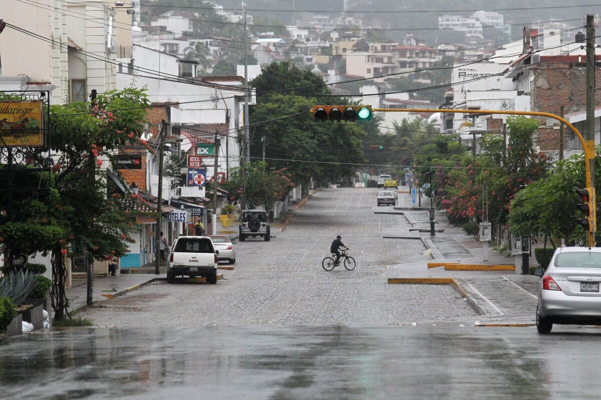 A cyclist rides along an empty street ahead of Hurricane Patricia, in Puerto Vallarta, Mexico.