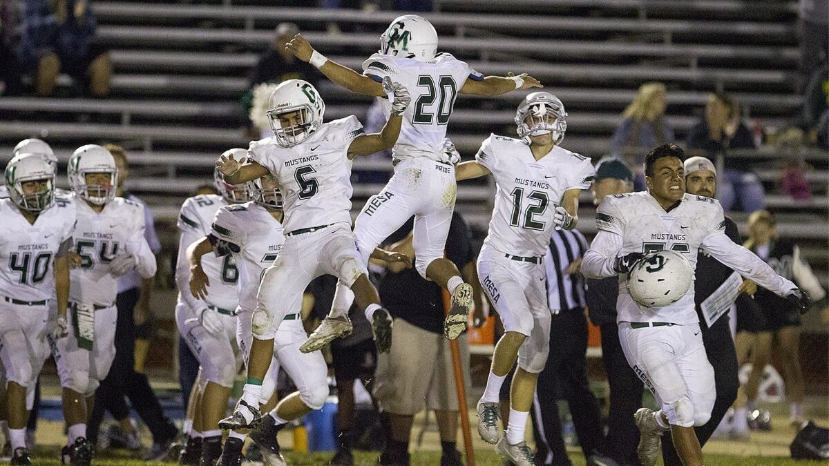 Costa Mesa High's players celebrate a 13-9 victory over Los Amigos on Sept. 14, 2017. The win was one of three for the football team last year.