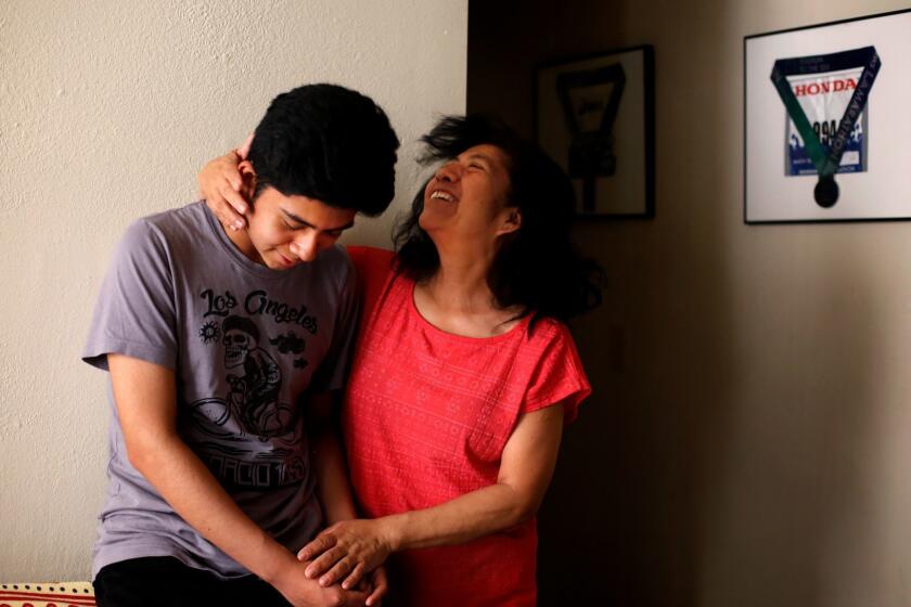 LOS ANGELES, CA-APRIL 18, 2019: Oswaldo ?Ozzie? Vasquez smiles with his mom, Eva Vasquez, right, at their home on April 18, 2019, in Los Angeles, California. They left the U.S. for Mexico when Ozzie was a child, but they came back when he was a teen and now is a senior at Miguel Contreras High School who will be attending Harvard University in the fall. (Photo By Dania Maxwell / Los Angeles Times)