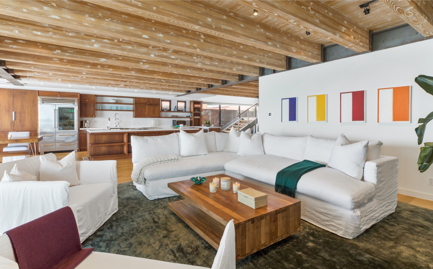 The architectural beach house expands to two levels of wood decks overlooking the ocean.