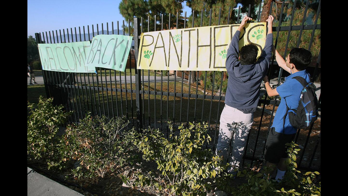ASB members Arvin Sarkissian, 17, and Aren Petrossian, 15, hang a "Welcome Back Panthers" sign for the first day of school at Clark Magnet High in Glendale on Monday, Aug. 8, 2016.