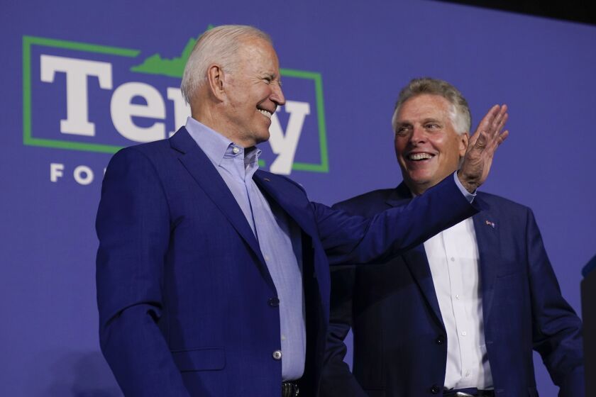 President Joe Biden stands with Virginia democratic gubernatorial candidate Terry McAuliffe during a campaign event McAuliffe at Lubber Run Park, Friday, July 23, 2021, in Arlington, Va. (AP Photo/Andrew Harnik)