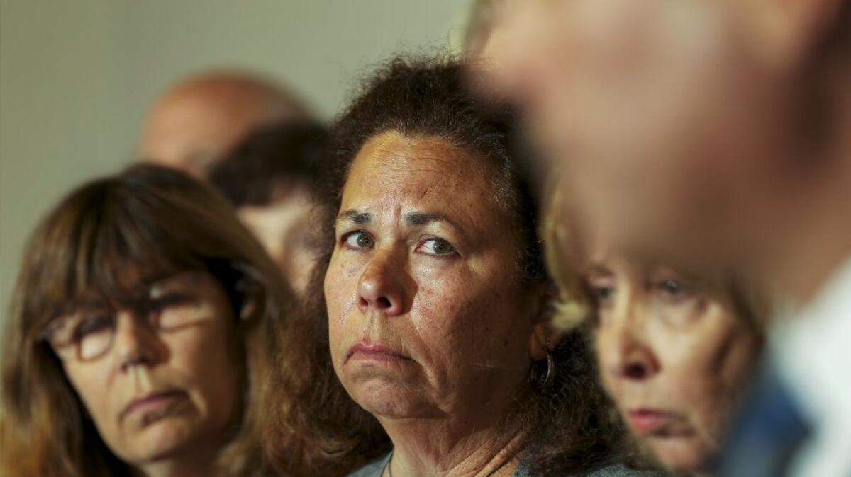 Sheryl Tidus, center, is flanked by family members at a news conference last month about a $100,000 reward for help finding the killer of her husband, Jeffrey Tidus.