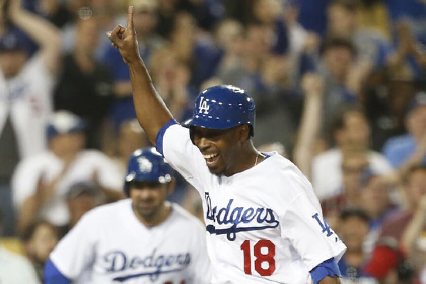 Dodgers pinch hitter Chone Figgins celebrates as he scores the winning run on a double by Carl Crawford in the 10th inning of the Dodgers' 3-2 win over the Detroit Tigers on Tuesday.