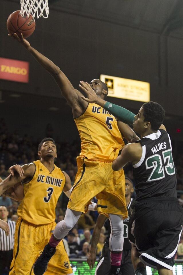 UC Irvine's Chris McNealy goes up or a lay up against Hawaii's Aaron Valdes during a game on Saturday.